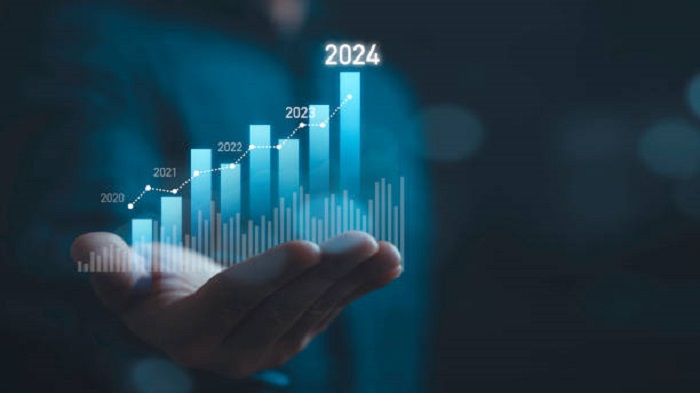 Homme d'affaires tenant un graphique technique virtuel lumineux pour l'analyse du marché en 2024 - l'île Maurice - Activ Solution
