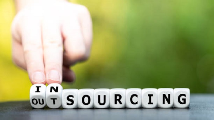 La main tourne les dés et remplace le mot « outsourcing » par « insourcing » - réussir une externalisation offshore à Maurice - Activ Solution
